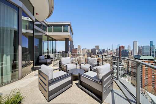 Luxury rooftop terrace with outdoor seating and sweeping Chicago skyline views in South Loop apartments