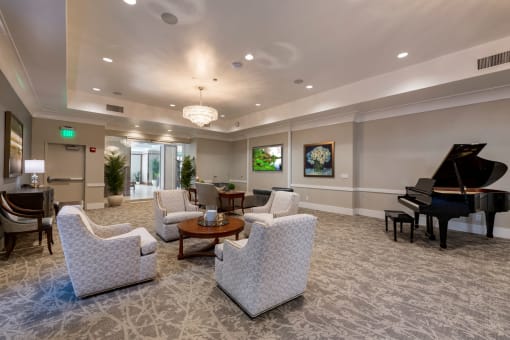 Social room with seating area and a piano