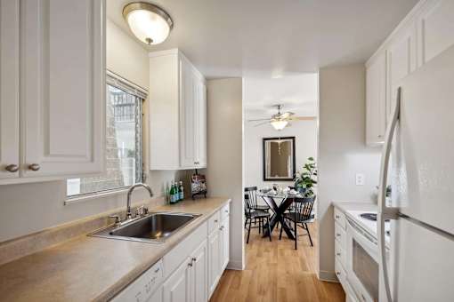 A kitchen with a table and chairs in the middle of the room.