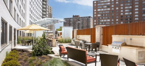 a rendering of a rooftop patio with a grill and dining area