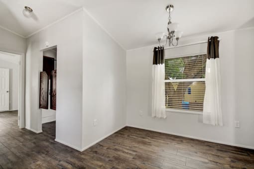 a bedroom with a large window and white walls