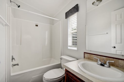 a bathroom with a toilet sink and bathtub
