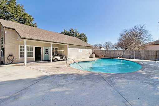 A house with a pool in the backyard.