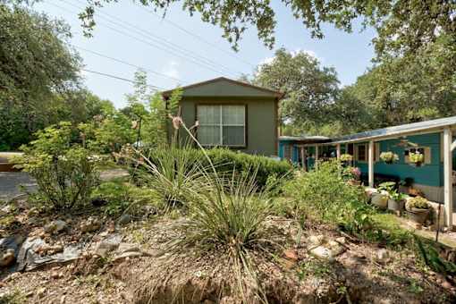 a house with a yard with plants and trees