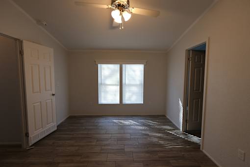 an empty living room with a ceiling fan and a window at Circle Park, Wyoming