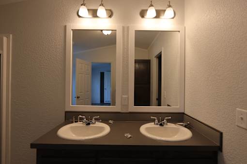 a bathroom with two sinks and two mirrors at Circle Park, Cheyenne, Wyoming