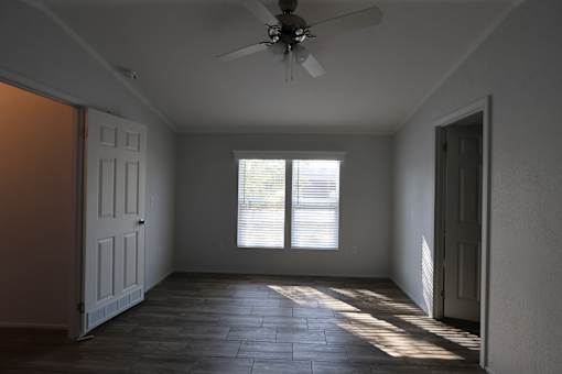 an empty room with a ceiling fan and a window at Circle Park, Cheyenne, WY