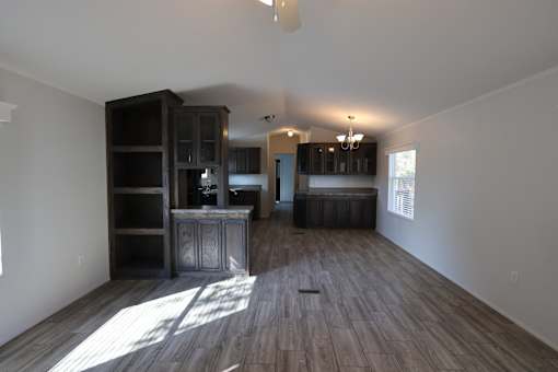 an empty living room with wooden floors and a kitchen at Circle Park, Wyoming, 82007