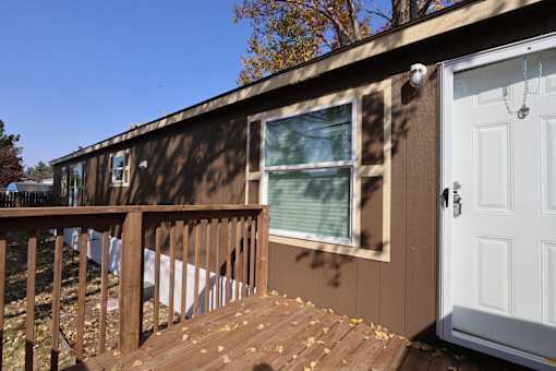 the tiny house has a deck with a door and a window at Circle Park, Wyoming, 82007