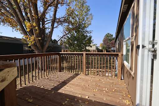 a backyard deck with a tree and a blue sky at Circle Park, Cheyenne, WY