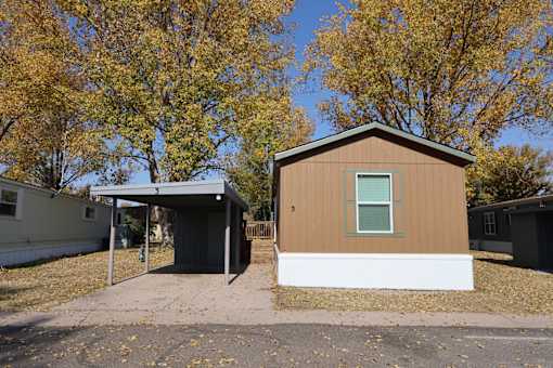 the front of a small house with a garage and trees at Circle Park, Cheyenne, 82007
