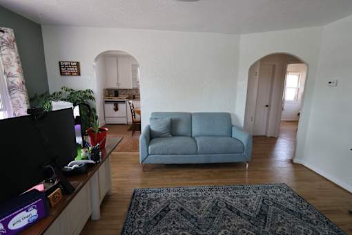 a living room with a blue couch and a tv at Country Lane, Wyoming