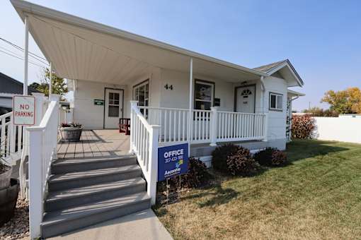 the front of a white house with a porch and a no parking sign at Country Lane, Cheyenne, WY