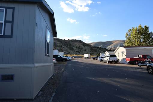 a parking lot in a trailer park with mountains in the background at Horizon MHC, Rock Springs, WY 82901