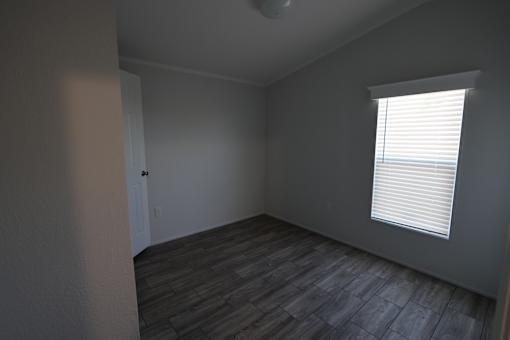 an empty room with wood floors at Horizon MHC, Rock Springs