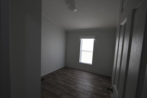 an empty room with a window and wooden floors at Horizon MHC, Wyoming