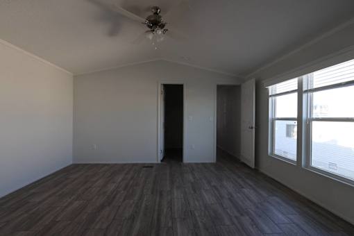 an empty living room with wood floors and a ceiling fan at Horizon MHC, Rock Springs, 82901