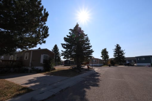 the sun shining over a street in a neighborhood with houses at Kimberly Village, Cheyenne, WY