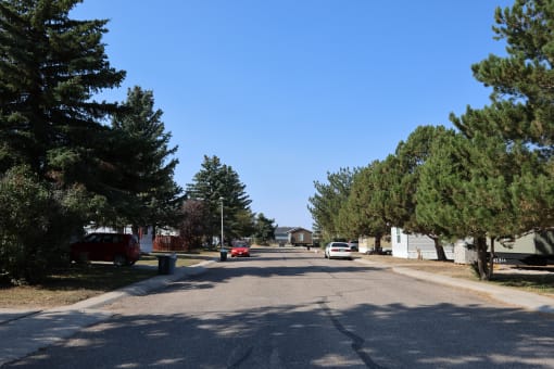 a street in a neighborhood with trees and cars on it at Kimberly Village, Cheyenne, WY