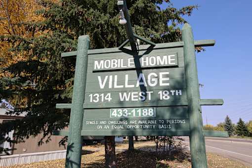 a sign for mobile home village at Mobile Home Village, Cheyenne