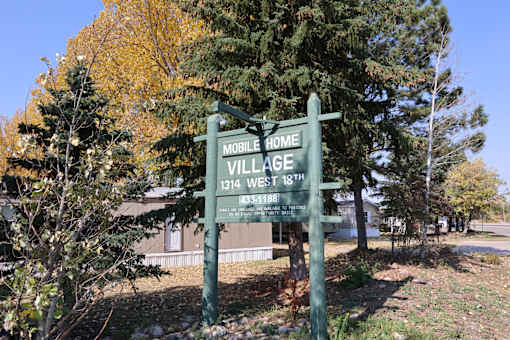 the sign for mobile home village in front of a house at Mobile Home Village, Cheyenne, WY