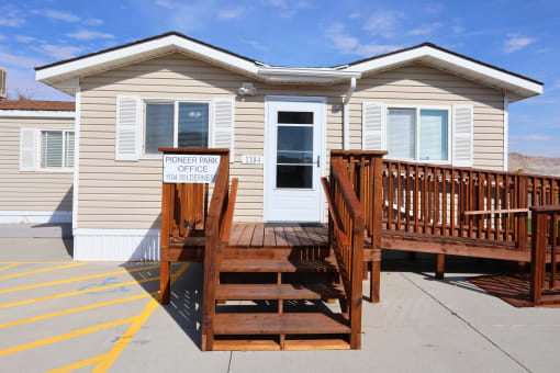 a yellow tiny house with a wooden deck in front of it at Pioneer Park, Green River