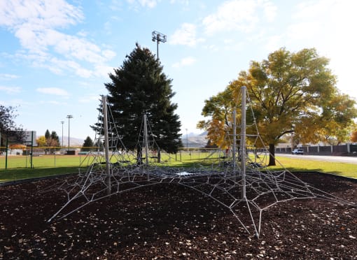 a large spider web sculpture in a park at Pioneer Park, Green River, WY