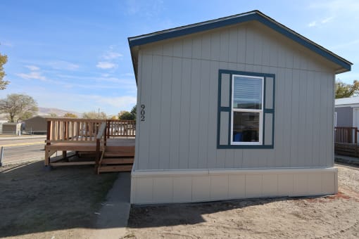the tiny house has a porch and a deck with a window at Pioneer Park, Green River