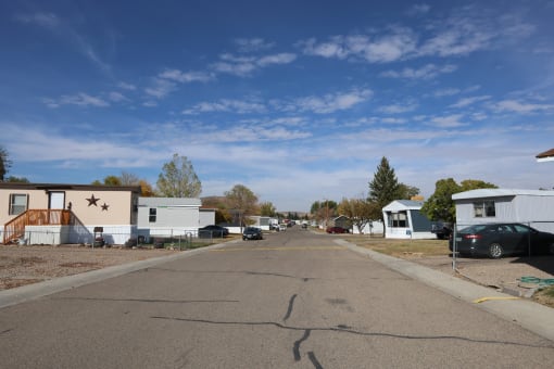 a street with houses and cars parked on the side of it at Pioneer Park, Green River, WY