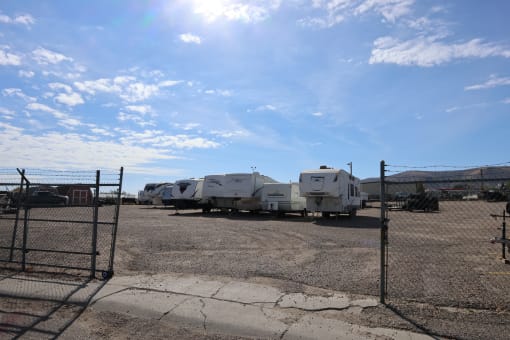 a row of trailers parked in a lot behind a fence at Pioneer Park, Green River