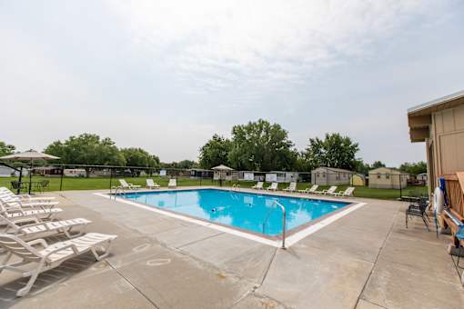 Pool With Relaxing Chairs at Heritage Oaks, Nebraska, 68521
