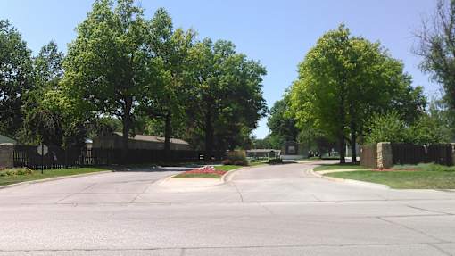 A street with a sidewalk and a fence.