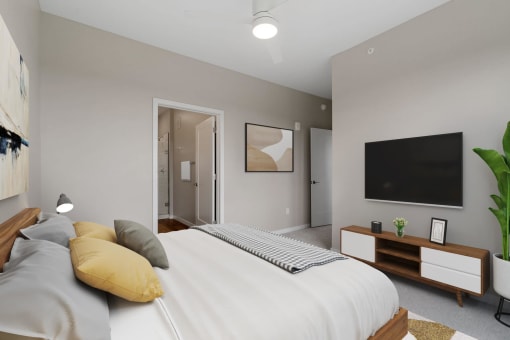 a bedroom with a large bed and a tv