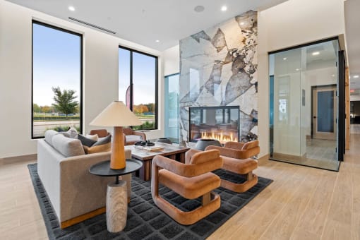 a living room with a fireplace and chairs