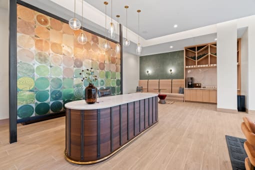 a large kitchen with a marble counter top and a colorful wall