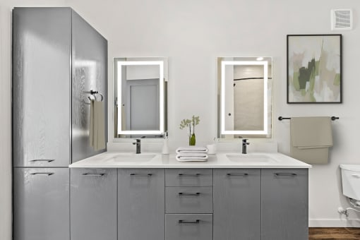 Double Vanity Bathroom with Gray Cabinets at Azalea Apartments