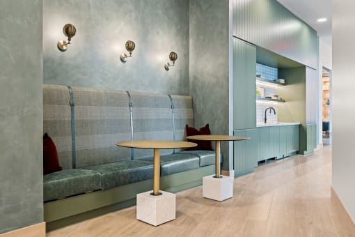a seating area with two tables in front of a couch