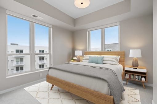a bedroom with a bed and three windows