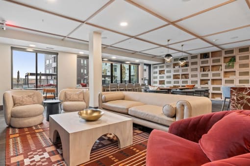 a living room with couches and chairs and a table