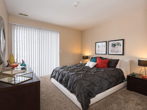 Beautiful Bright bedroom with a wide window at Reflection Cove Apartments in Manchester, MO, 63021