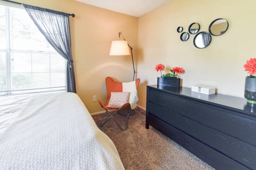 a bedroom with a bed and a dresser  at Riverset Apartments, Memphis