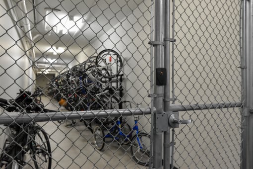 a bunch of bikes are piled up behind a fence at Park 205, Park Ridge, IL, 60068
