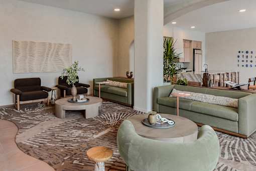 A living room with a green couch and a wooden coffee table.