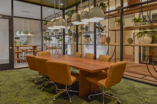 A conference room with a long table and chairs.