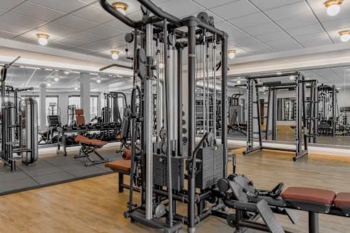 A gym with a variety of equipment including a leg press machine.