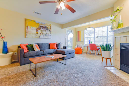a living room with a couch coffee table and fireplace at Riverset Apartments in Mud Island, Memphis, TN