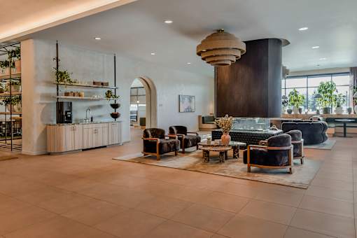 A modern living room with a large sofa, armchairs, and a coffee table.