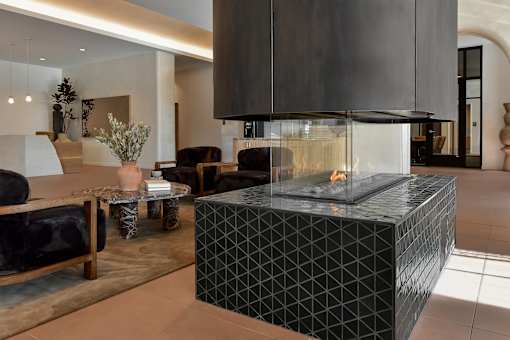 A modern living room with a black and white geometric coffee table.