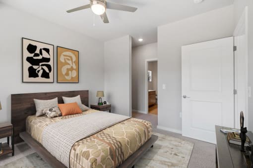 a bedroom with a bed and a ceiling fan at The Aurilla, Cottage Grove, MN, 55016