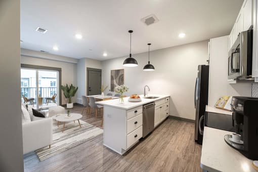 a kitchen and living room in an apartment at The Commons at Rivertown, Grandville, 49418